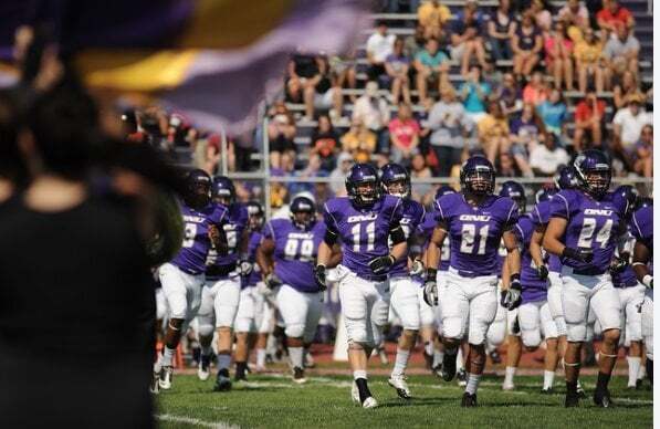Claude responded: An Olivet Nazarene University football team in purple uniforms takes the field as fans watch from the stands.An Olivet Nazarene University football team in purple uniforms takes the field as fans watch from the stands.